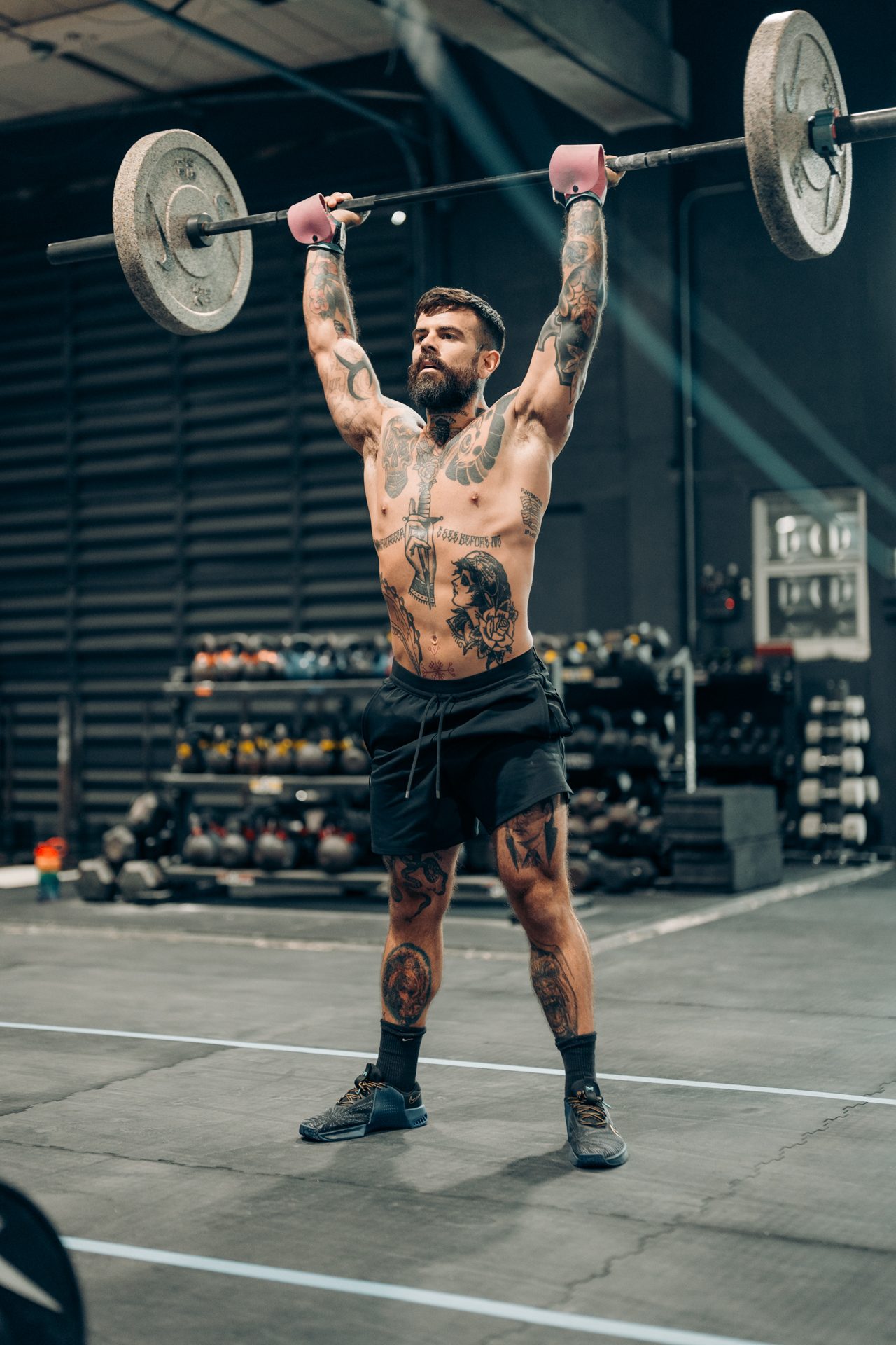 Overhead barbell lockout in a CrossFit gym
